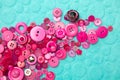 Pink buttons on turquoise background