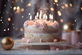 Pink cake with candles around confetti sprinkles and bokeh effect. New Year\'s fun and festiv Royalty Free Stock Photo