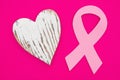 Pink cancer ribbon with weathered heart on bright pink textured felt material