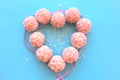 Pink candy on a blue and pink background folded in a heart with a ribbon Royalty Free Stock Photo