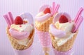 Pink candy ice creams in cones.