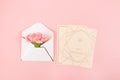 Pink carnations flower with card on pink background.