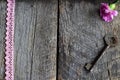 Pink carnations, ribbon and old key on the wooden, vintage background Royalty Free Stock Photo