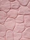 Pink cement wall in huge stones, plaster background