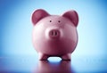 Pink ceramic piggy bank on blue Royalty Free Stock Photo