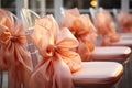 Pink chairs with peach fuzz color flower shape decorative bows. Wedding dinner set up. Celebration Copy space Royalty Free Stock Photo