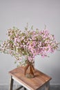 Pink chamelaucium, wax flower on gray background, copy space. The work of the florist at a flower shop. Fresh cut flower Royalty Free Stock Photo