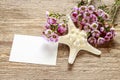 Pink chamelaucium wax flower and starfish on wooden background Royalty Free Stock Photo