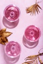 Pink champagne in luxury crystal glasses and classy christmas decor. Top view. New year eve celebration and nightclub party with