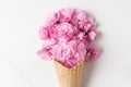 Pink cherry blossoming flowers bouquet in ice cream cone on white background. wedding or holiday background Royalty Free Stock Photo