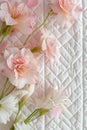 Pink cherry blossoms arranged on a wavy quilted ivory fabric