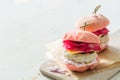 Pink chicken grill burger on wood background