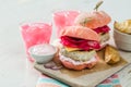 Pink chicken grill burger on wood background