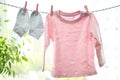 Pink child cloth and socks hanging on twine Royalty Free Stock Photo