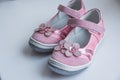 Fashion baby pink sandals with pink flowers.Baby Kid`s modern sneakers shoe on white background. A pair of pink Royalty Free Stock Photo