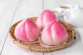 Pink Chinese peach birthday bun food on white table background