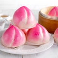 Pink Chinese peach birthday bun food on white table background Royalty Free Stock Photo