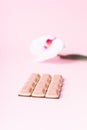 Pink chocolate bar and flower on pink background. Ruby new chocolate. New pink sweet dessert Royalty Free Stock Photo