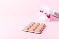 Pink chocolate bar and flower on pink background. Ruby new chocolate. New pink sweet dessert Royalty Free Stock Photo