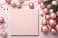 Pink Christmas background with blank paper and decorations on a pink background. Royalty Free Stock Photo