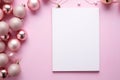 Pink Christmas background with blank paper and decorations on a pink background. Royalty Free Stock Photo