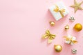 Pink Christmas background with golden decorations, gift boxes, balls, confetti, bow, star. Christmas minimal stylish composition, Royalty Free Stock Photo