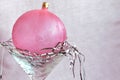 Pink Christmas ball on silver hair in a stem glass Royalty Free Stock Photo