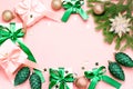 Pink Christmas card or New Year background, flat lay, copy space. Pastel pink gift boxes and green, golden decorations and Royalty Free Stock Photo