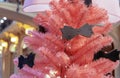 Pink Christmas tree decorated with black bows