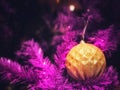 Pink christmas tree decorated with fancy gold christmas ball and beautiful ornaments