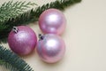 Pink Christmas Tree Glass Balls and and Fir Branches on Ivory Background with Copy Space Royalty Free Stock Photo