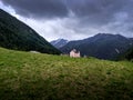 A pink church on a hill surrounded by mountains Royalty Free Stock Photo