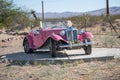 Pink classic convertible car in the Arizona desert.