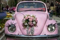 Pink classic convertible car and flowers on hood