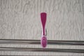 Pink clip for linen on a metal tube