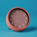 pink clock without hands on a blue background