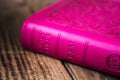 Pink closed bible on wooden background Royalty Free Stock Photo