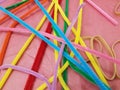 Pink cloth and colorful pipe cleaners and rubber bands Royalty Free Stock Photo