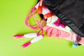 Pink clothes and accessories for fitness, a bottle of water, a notebook for writing, in a sports bag, on a light green background Royalty Free Stock Photo