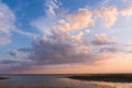 Pink clouds in evening sky over lake Royalty Free Stock Photo