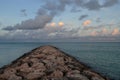 Pink Clouds Over a Rock Jetty Coastal Aruba Royalty Free Stock Photo