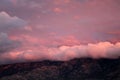 Pink clouds rolling over the catalina mountains at sunrise in Tucson, Arizona Royalty Free Stock Photo