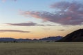 Pink clouds at sunset aboe yellow dry grass Royalty Free Stock Photo