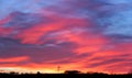 Pink cloudy sunset landscape over hill Royalty Free Stock Photo