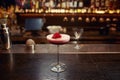 Pink cocktail decorated with rose floral petal on wooden bar counter desk Royalty Free Stock Photo