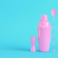 Pink cocktail shaker with jigger and mix spoon on bright blue background in pastel colors Royalty Free Stock Photo