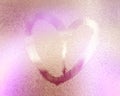 Pink color blurred lovely heart symbol drawn by hand on the wet rainy glass. Valentines day Royalty Free Stock Photo