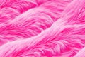 Pink color fur texture coral fluffy fabric coat background. Winter fashion color trends feminine flat lay seamless