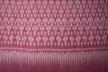 Pink color hand woven cotton fabric in Thai ancient style pattern Royalty Free Stock Photo