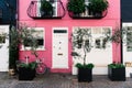 Pink color painted house at St Lukes Mews alley in London